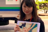 A photo of Ms Ishikawa holding her petition.