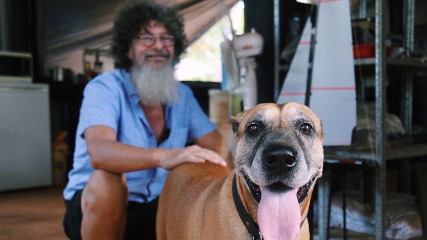 Andrew Walton pats his dog