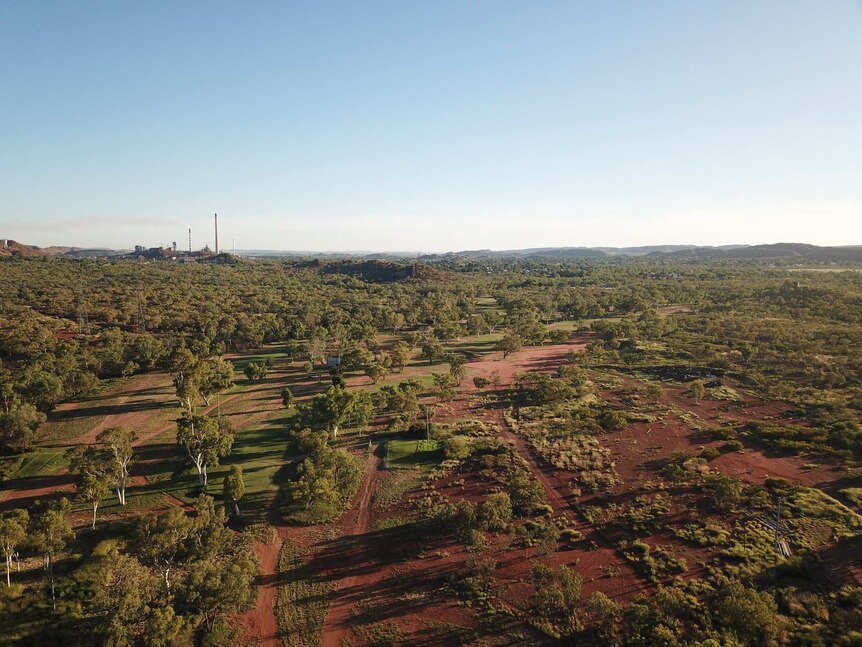 A drone shot of Mount Isa golf course, blue skies.