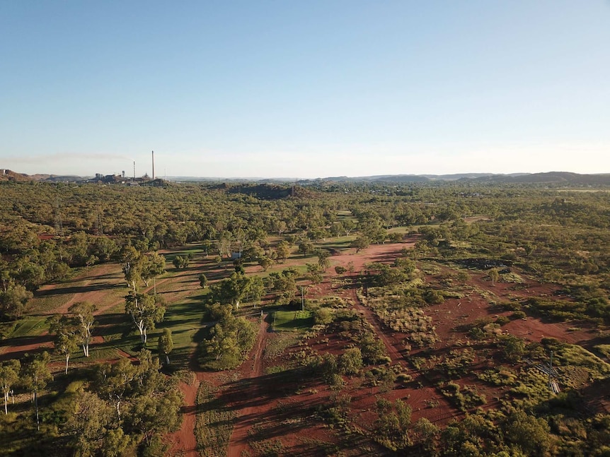 A drone shot of Mount Isa golf course, blue skies.