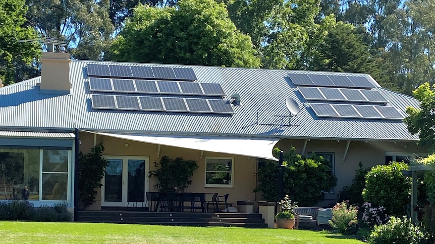 A single-story home with solar panels on the roof