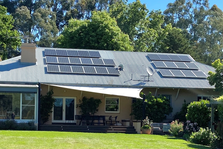 A single-story home with solar panels on the roof