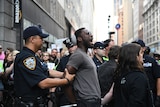 A man is arrested by police outside an Amazon store.