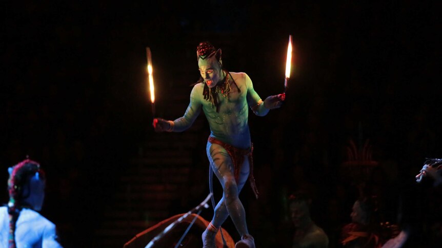 Peter Kismartoni with torches of fire performing in TORUK.