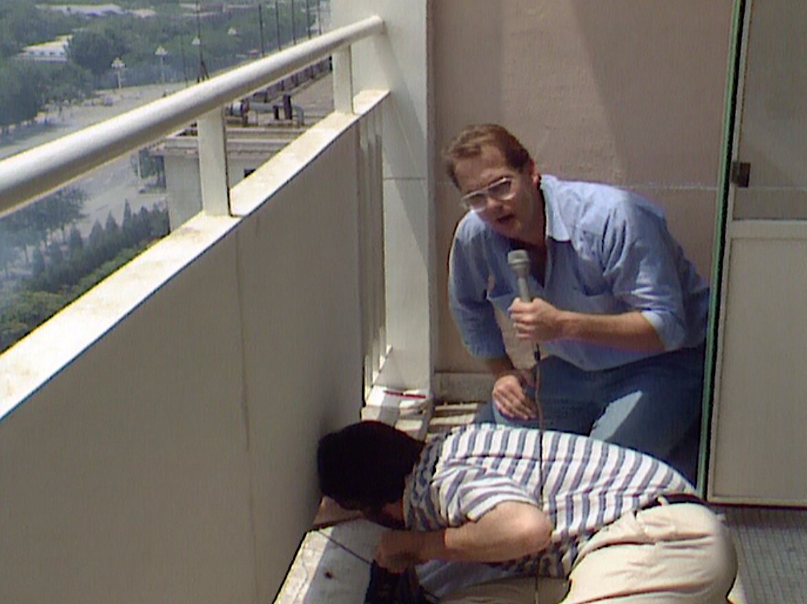 ABC journalist Max Uechtritz taking shelter on a hotel balcony while covering the Tiananmen Square massacre