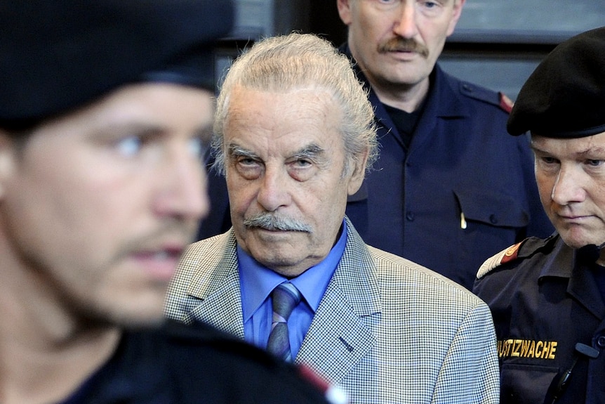 Josef Fritzl stands amid security guards 