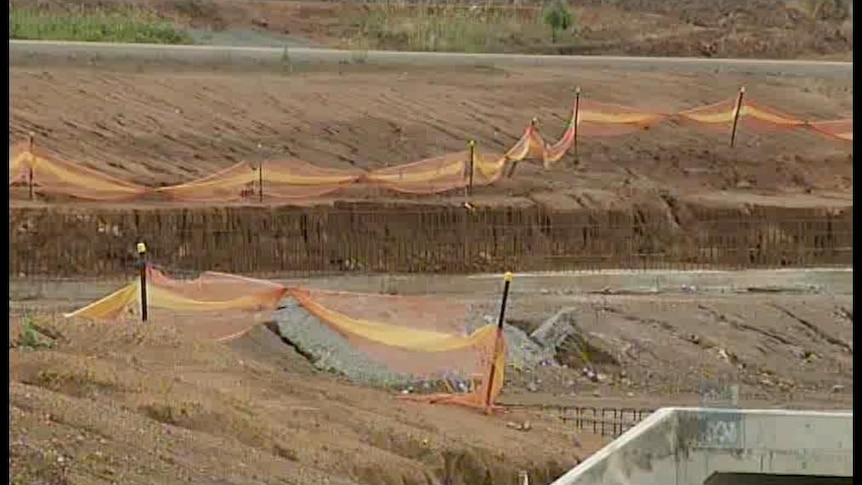 The pond project has blown out by $17 million after the discovery of 100,000 tonnes of asbestos-contaminated soil.