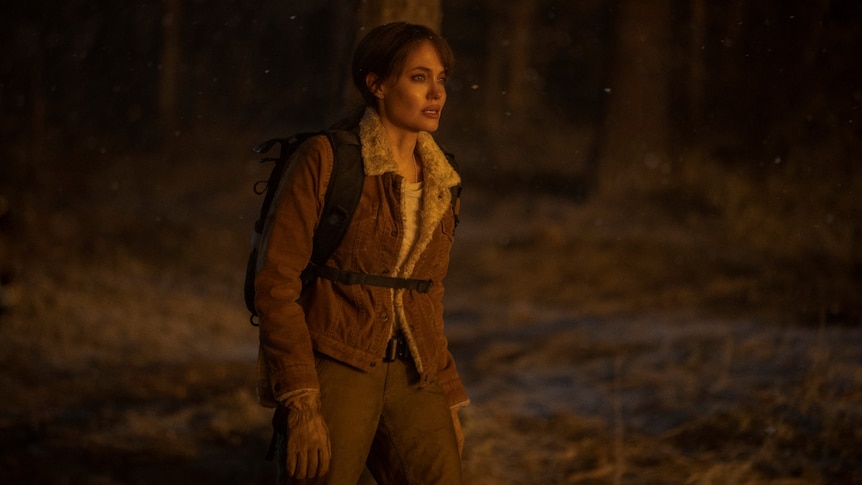 Film still of Angelina Jolie as Hannah in the forest at night from Those Who Wish Me Dead