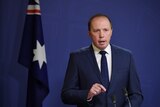 Peter Dutton speaks in front of Australian flag October 30, 2016
