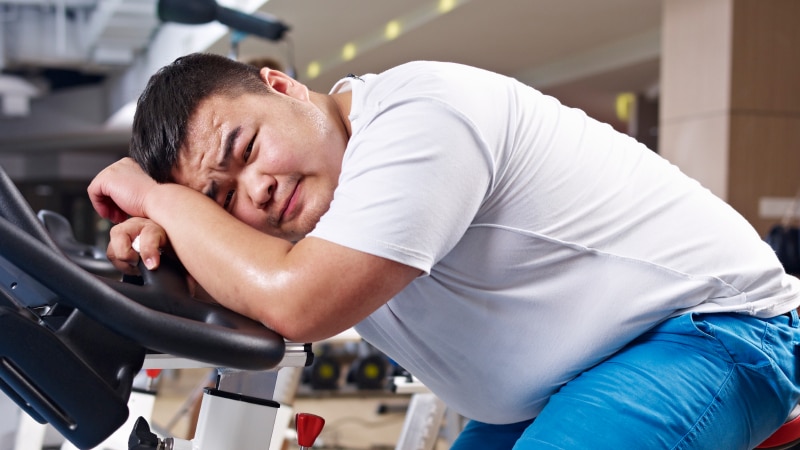 Man looking sad on exercise equipment