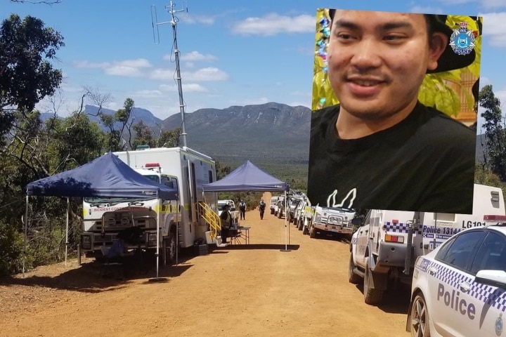 A row of police cars on a dirt road, with shade tents set up and the Stirling range in the background.