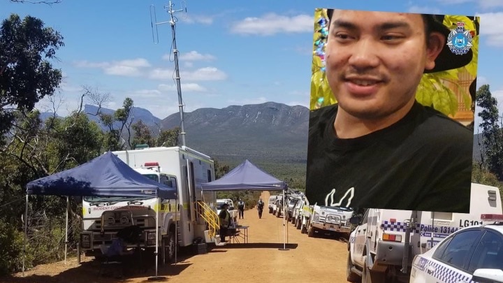 A row of police cars on a dirt road, with shade tents set up and the Stirling range in the background.