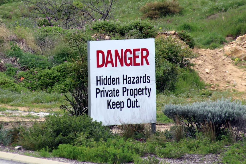 A "danger" sign sits on the land at Alkimos.