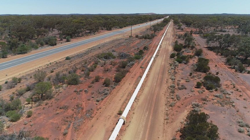 A water pipeline runs parallel to the Great Eastern Highway in WA.