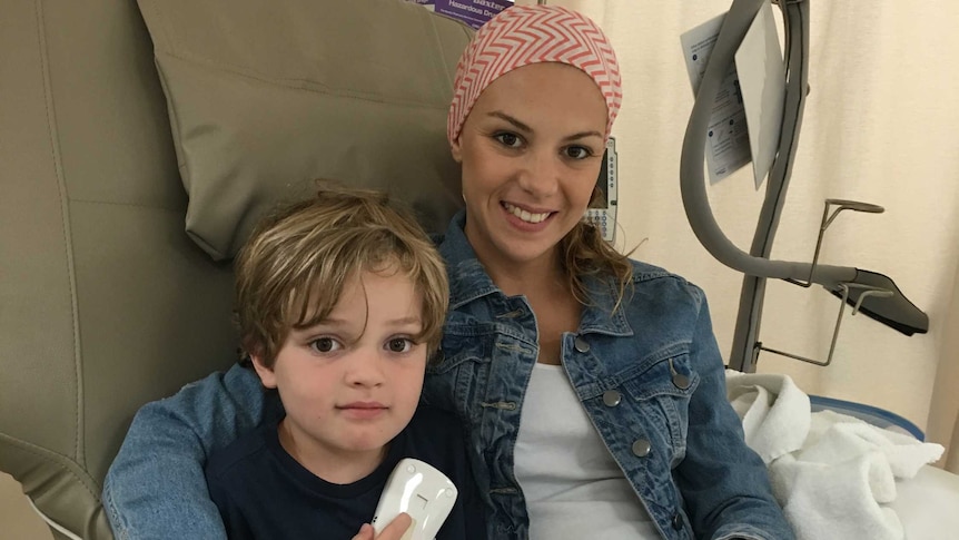 Cancer patient Amber hugs her son while undergoing treatment