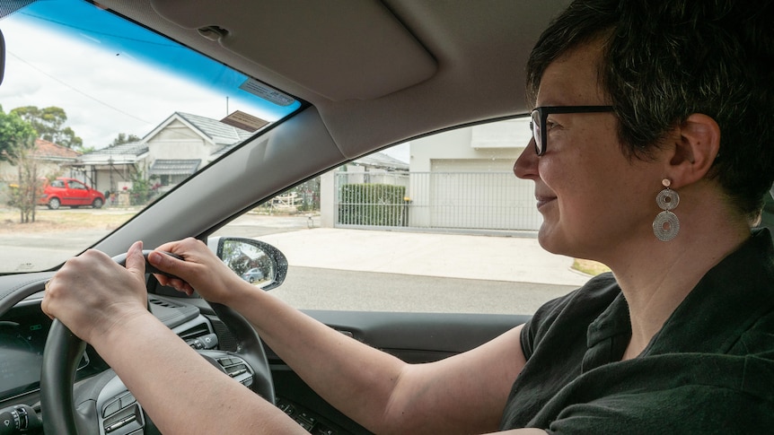 Woman behind the wheel of a car looking ahead