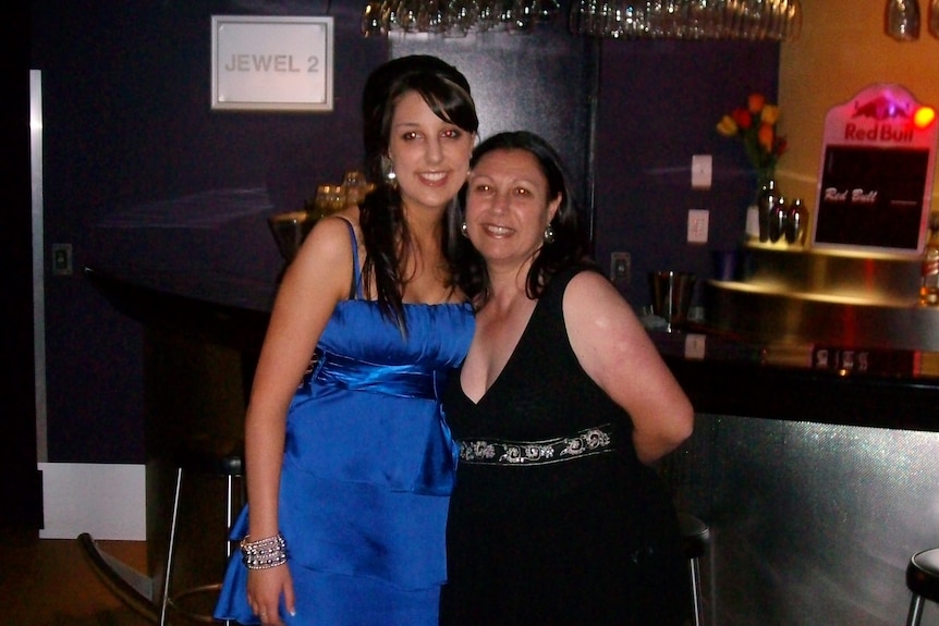 An older photo of Danielle Snelling and her mum Rosa. Danielle wears a blue dress and Rosa wears a black dress.
