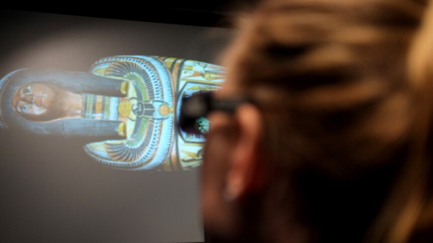A visitor takes in the 3D imagery of the mummy Nesperennub at the Queensland Museum.