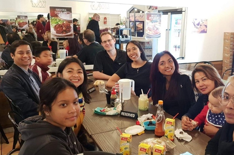 A group of people eating together at a restaurant.