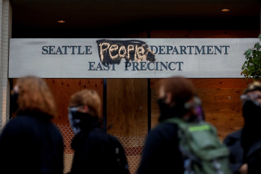 A sign reading 'Seattle People Department East Precinct" after the word 'police' was removed