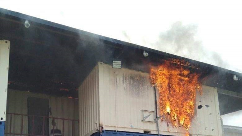 Fire engulfs a shippig container used as accommodation for refugees and asylum seekers on Manus Island, Papua New Guinea.