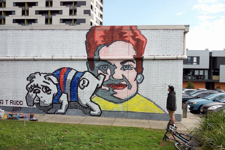 A mural in Footscray showing a bulldog cock his leg ove a depiction of Pauline Hanson's face.