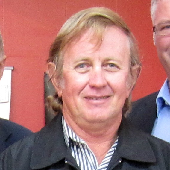 Headshot of man with fair hair and striped shirt