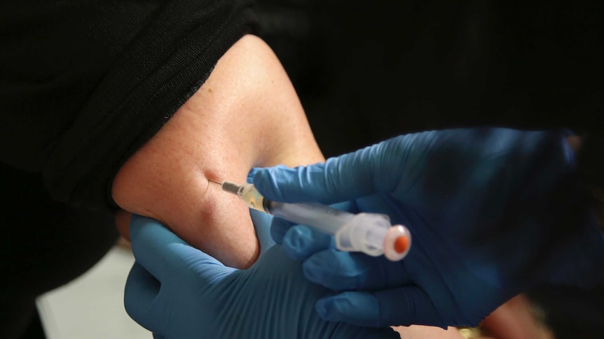 Close up of vaccine being injected into an arm
