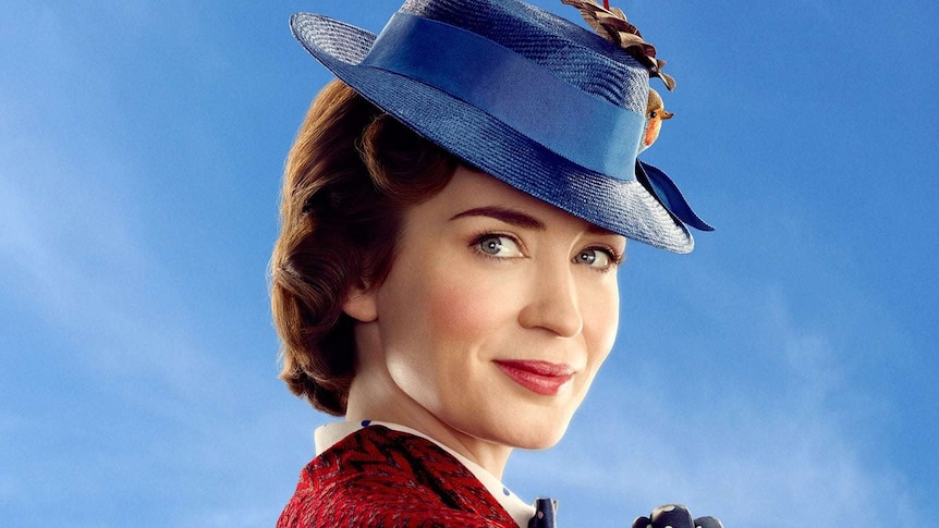 Emily Blunt in costume as Mary Poppins, wearing her hair in pin curls tucked up under a blue hat.