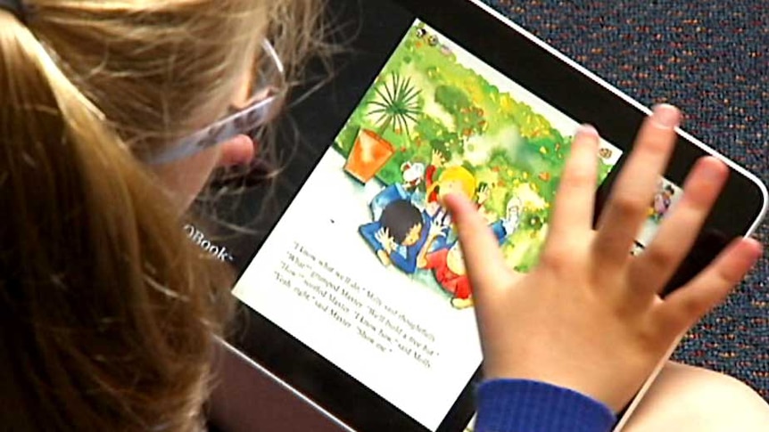 A primary school student uses an ipad (unidentified).