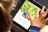 A primary school student uses an ipad.