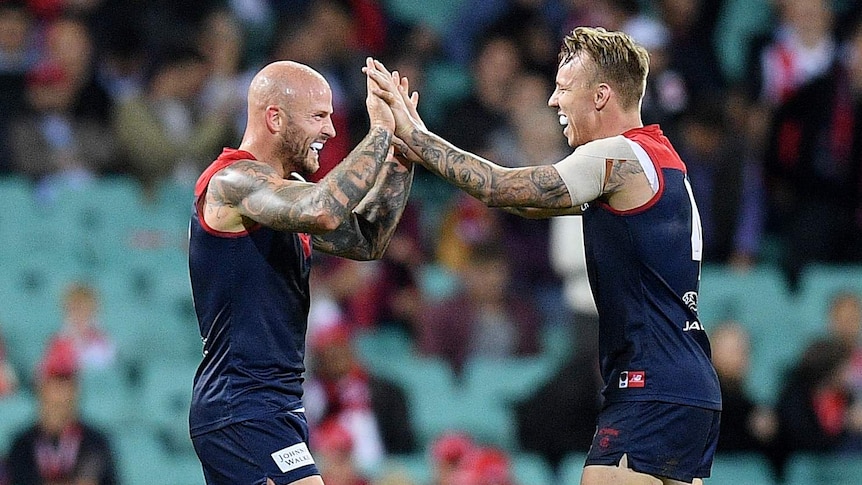 Nathan Jones and James Harmes high five each other