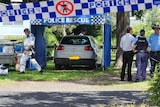 A police tent is set up around a car at Evans Head