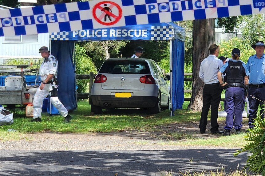 A police tent is set up around a car at Evans Head