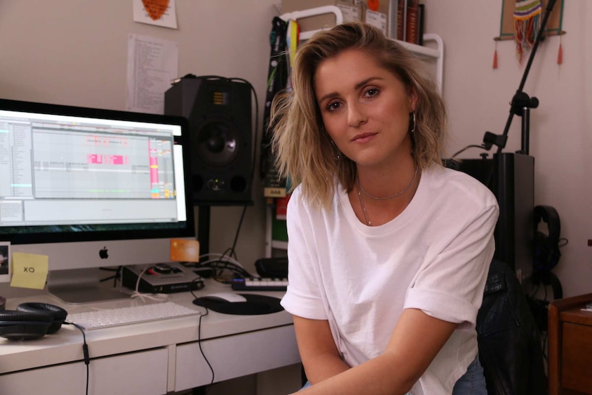 Musician KLP sitting at her desk.