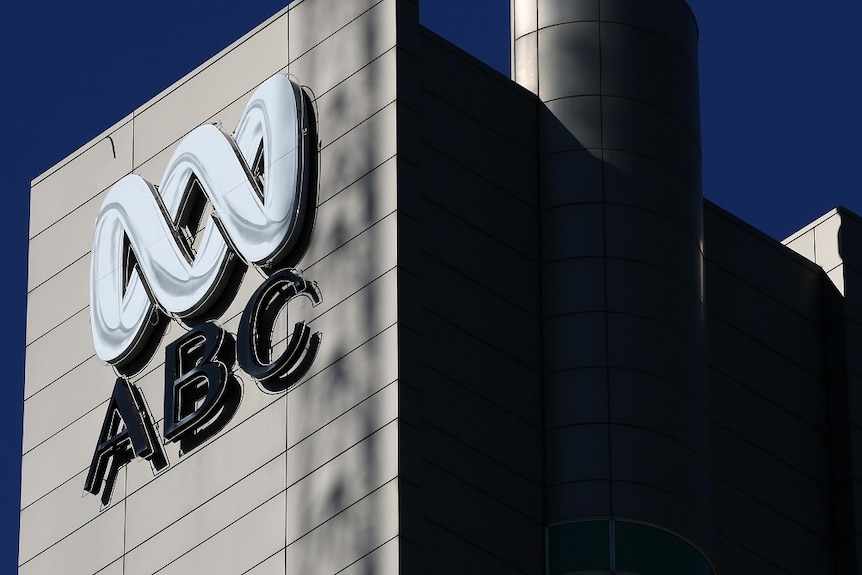 An ABC sign on the outside of a large building.