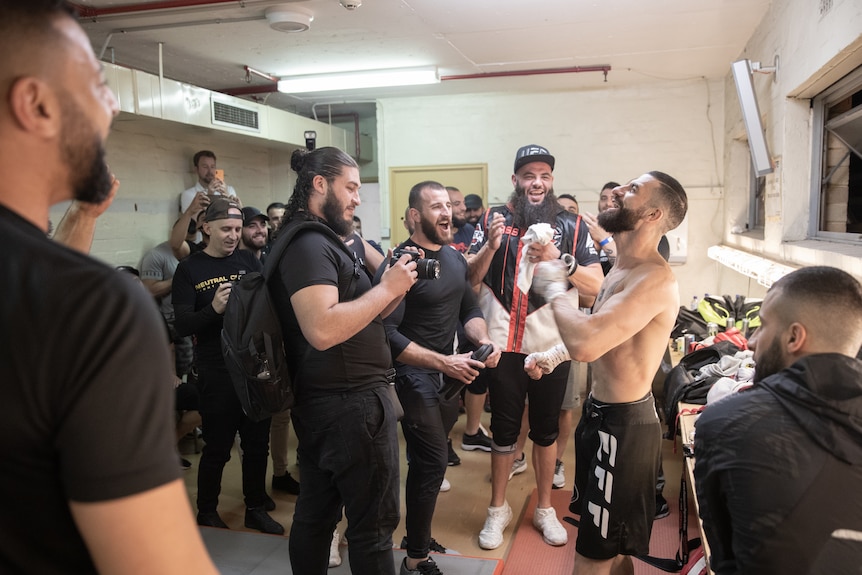 A group of men celebrate.