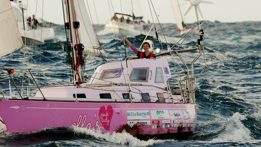 Teen sailor Jessica Watson waves as she sails into Sydney Harbour aboard her yacht, Ella's Pink Lady