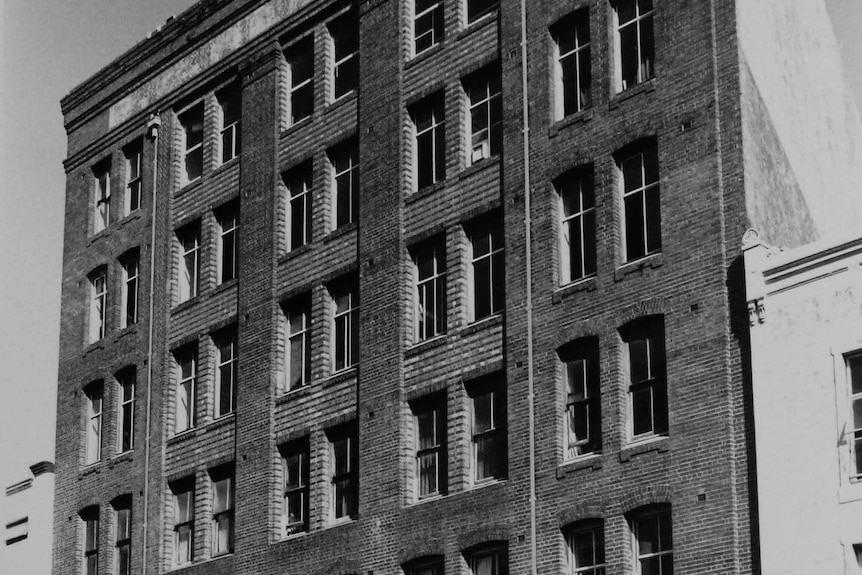 The original facade of the building as photographed in a bygone era.