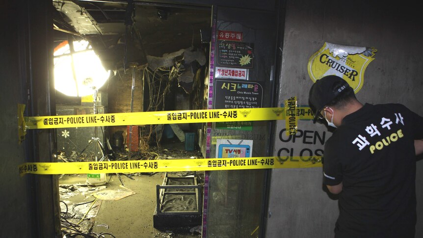 Crews at the scene of a karaoke fire in South Korea