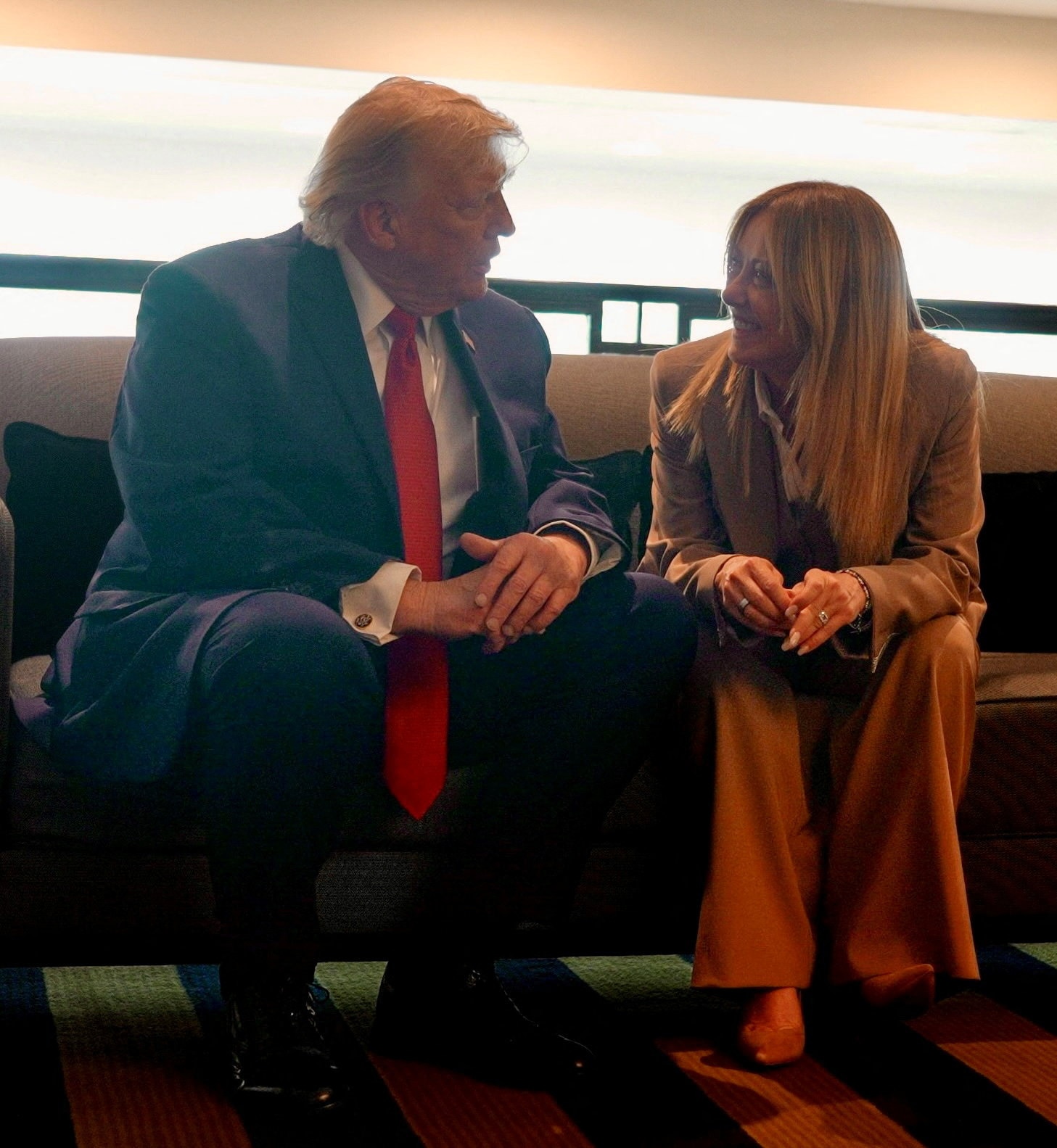 Donald Trump and Giorgia Meloni sitting down and talking 