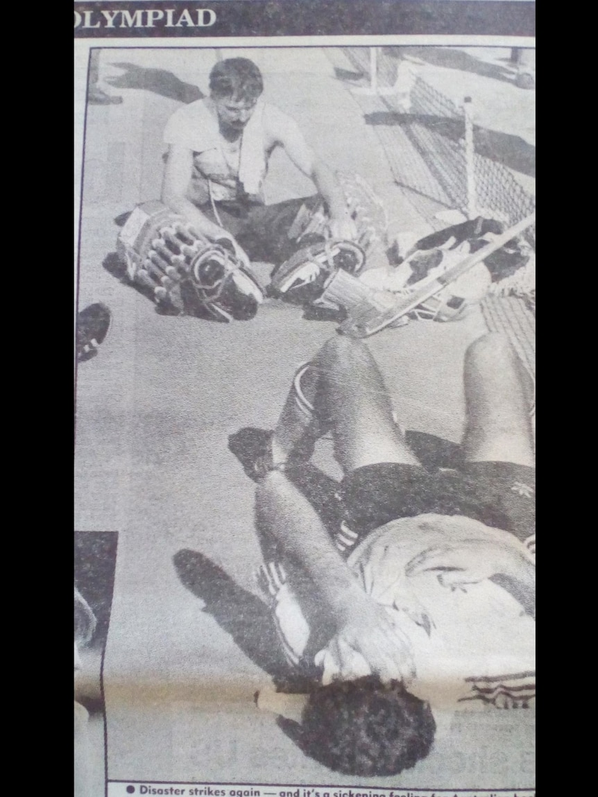 Newspaper clipping of men sitting on the ground