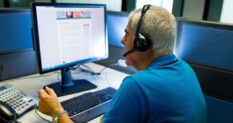 A man on a phone in a call centre