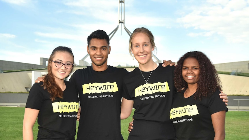 The four young members of the Step Up Heywire group pose together out the front of Parliament House in Canberra.