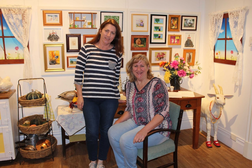 Two ladies inside a recreated cottage