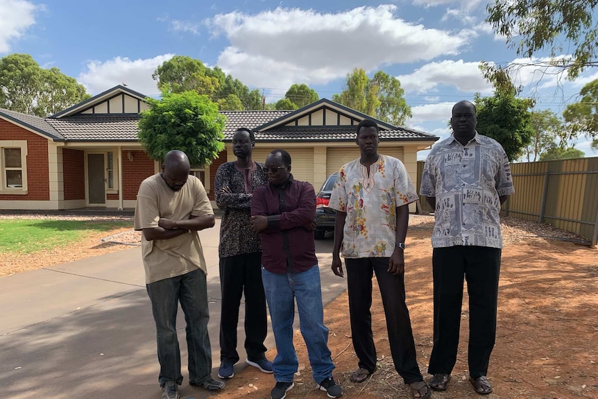 Family and elders of Bor Mabil outside a home.