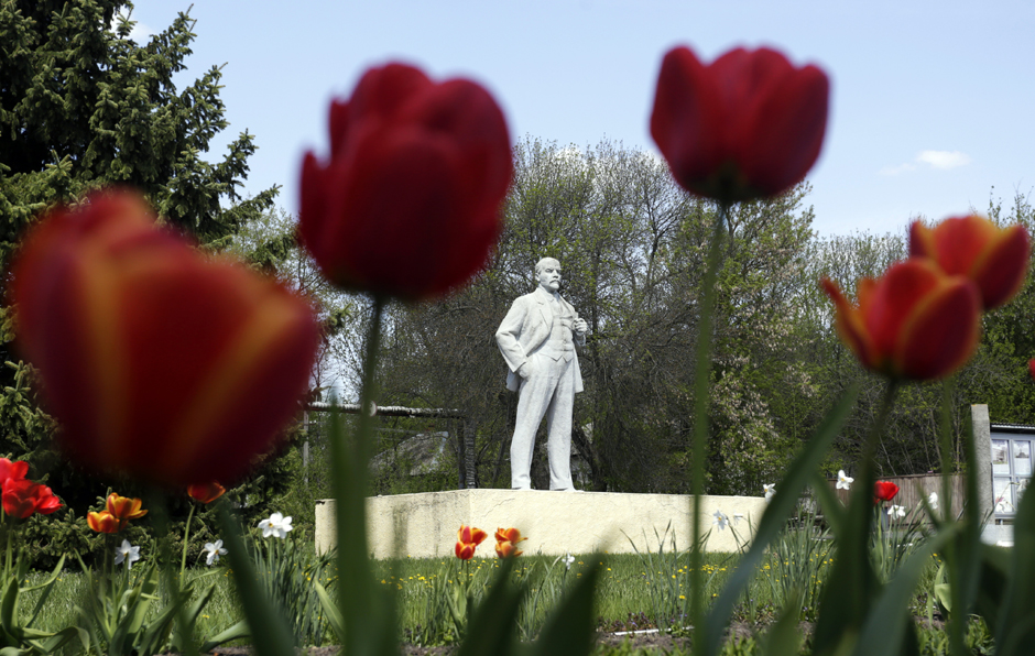 A statue of Soviet Union founder Vladimir Lenin stands amid flowers and trees in Chernobyl.