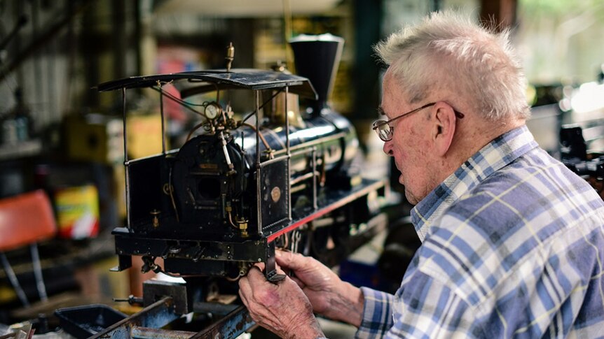 Rail enthusiast Neil MacKenzie, working on one of his miniature locomotives at his home on Brisbane