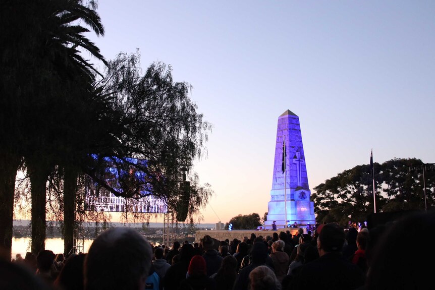The skies lighten over Kings Park, as purple light shines on the war memorial.