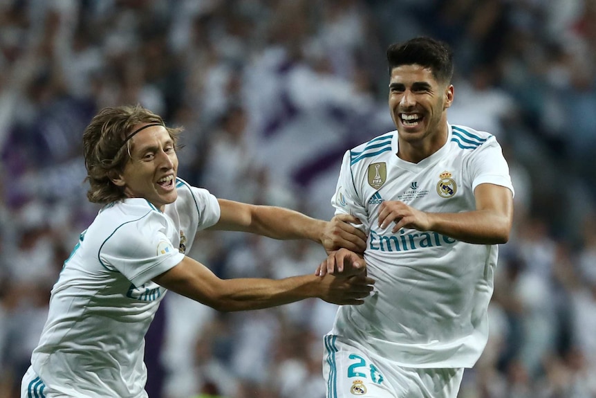 Real Madrid’s Marco Asensio celebrates scoring their first goal with Luka Modric.